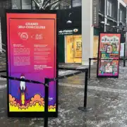 Totem d'exposition extérieur avec visuel coloré de fusée pour un jeu concours.